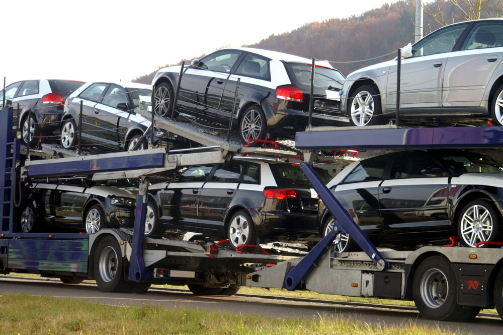 Cars loaded on an open trailer of the long-distance moving company
