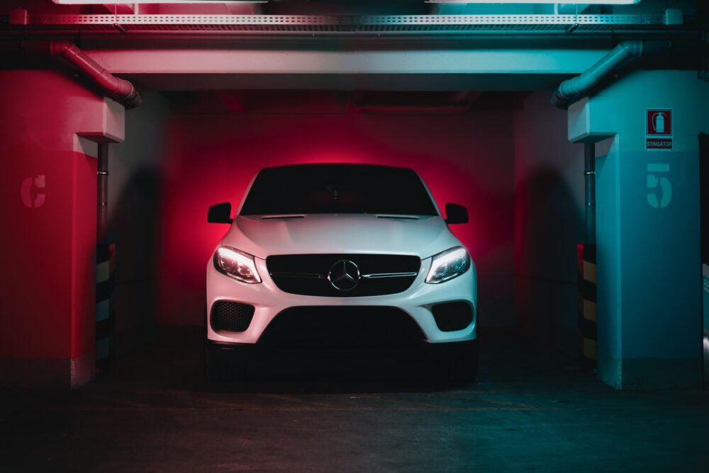 A white Mercedes car in a garage