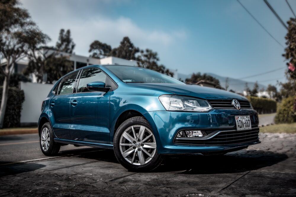 A blue car packed for long-distance moving