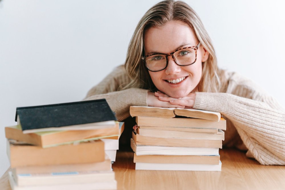 a girl is preparng to pack books for a long-distance moving