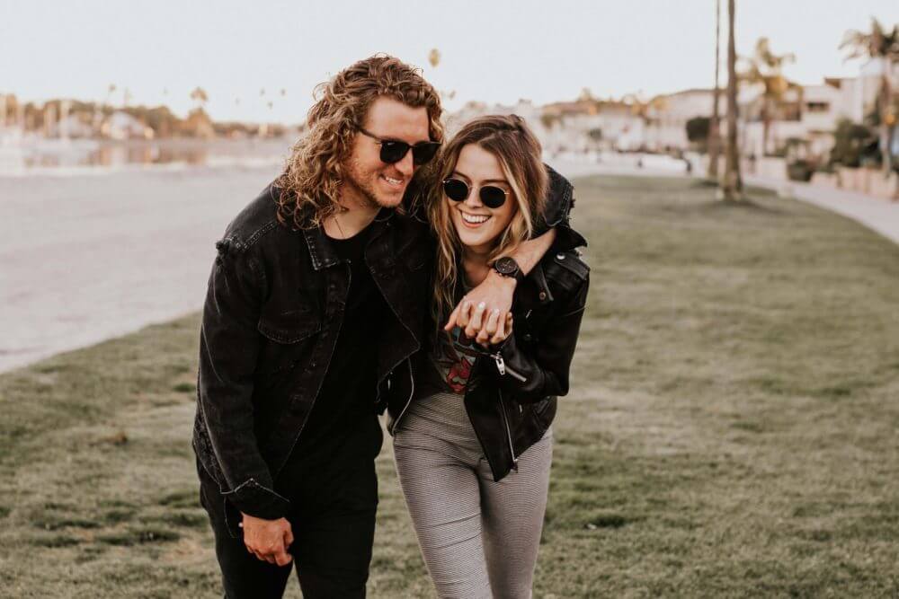 happy couple walking in the park