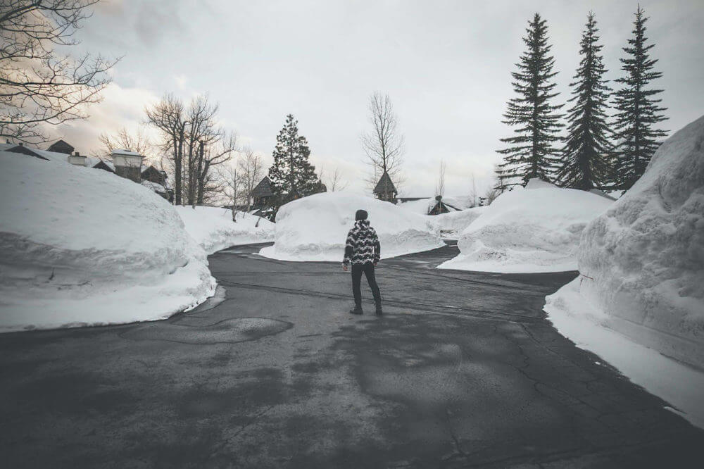 person standing in the middle of a clear pathway