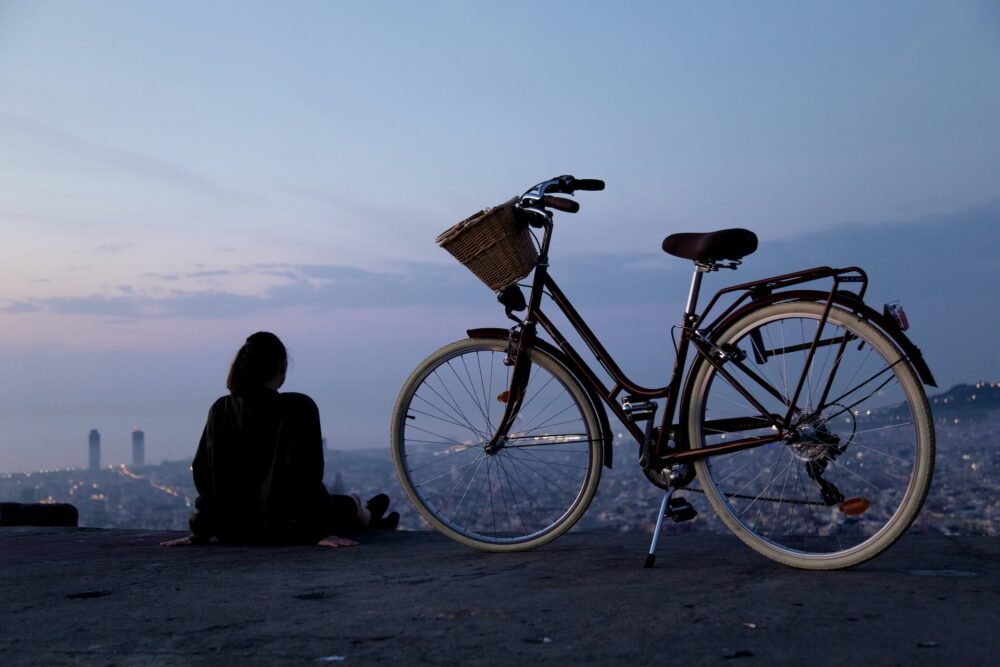 girl with bicycle on a hill