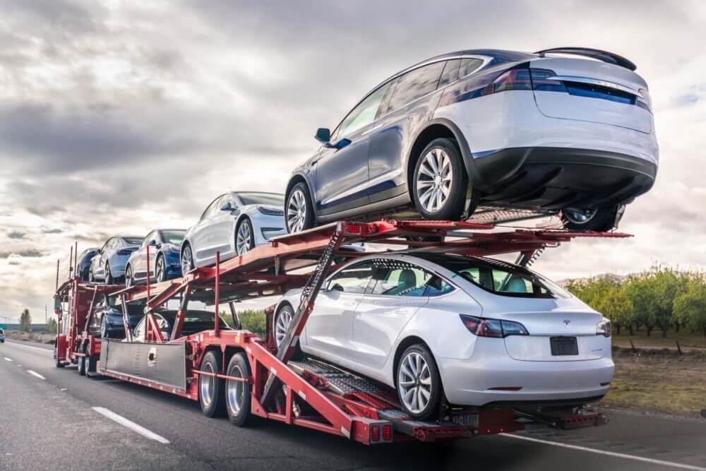 Cars on an open carrier of a long-distance moving company