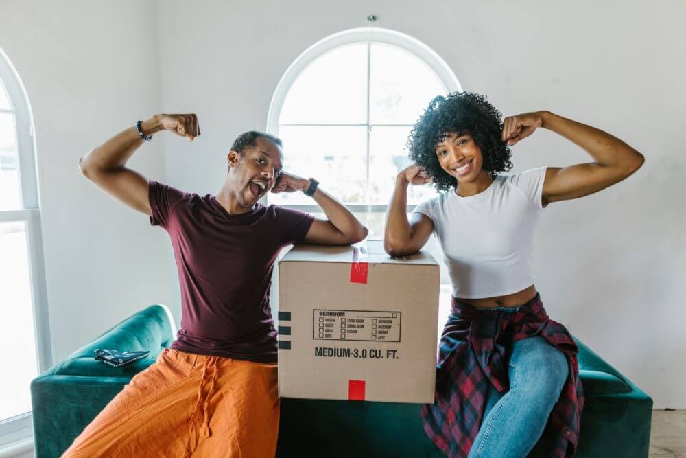 A woman and a man sitting after cross-country moving