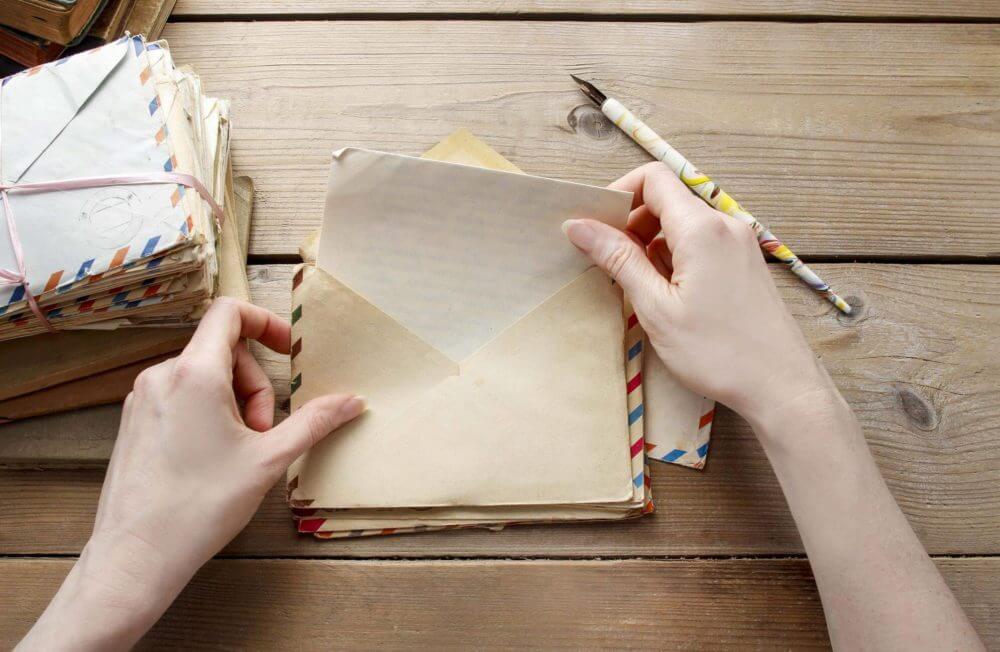 person opening a stack of letters