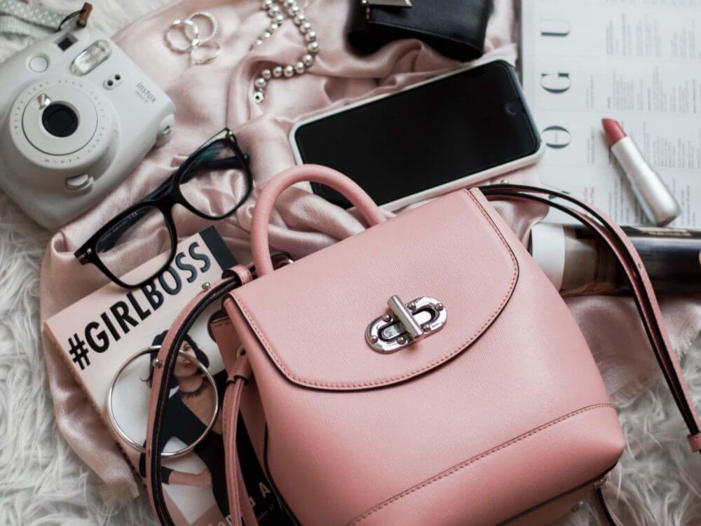 a pink purse on a bed