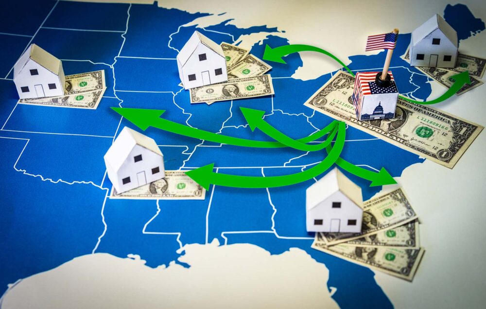 Family houses with dollar bills over a US map