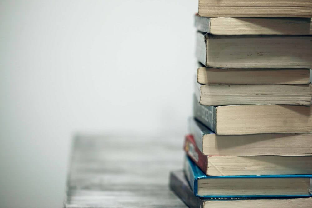 neatly stacked books on the table