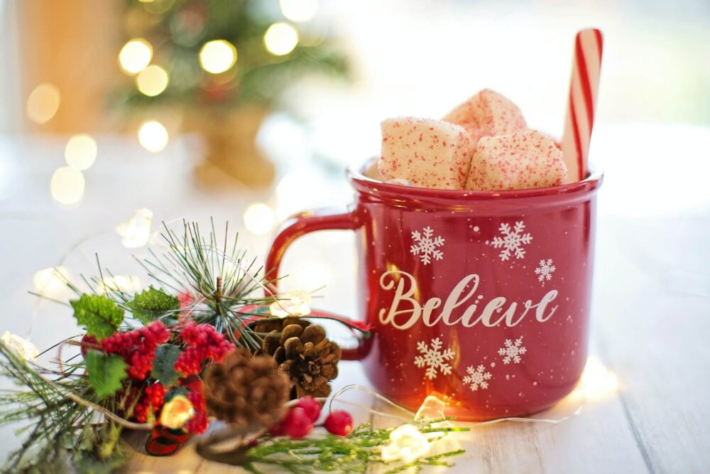 girl drinking coffee from a holiday mug