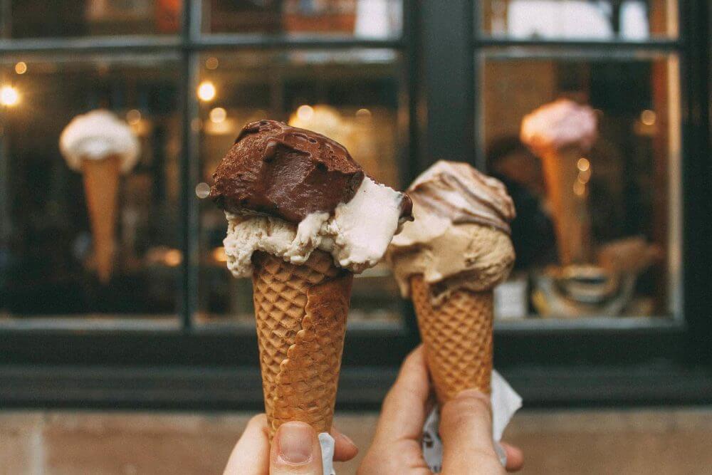 people holding ice cream cones