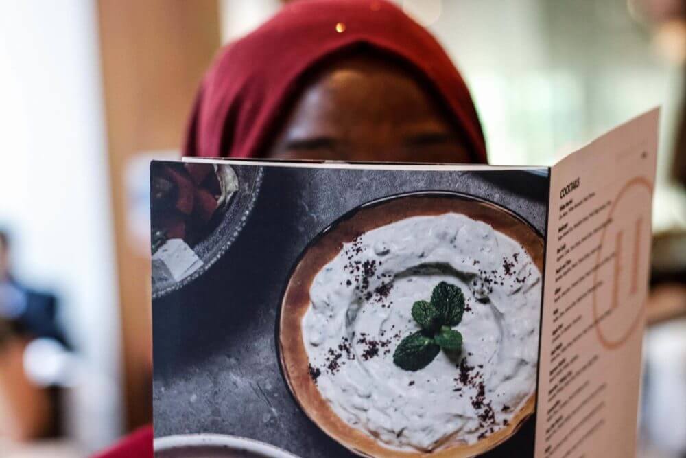 person holding a menu at the restaurant