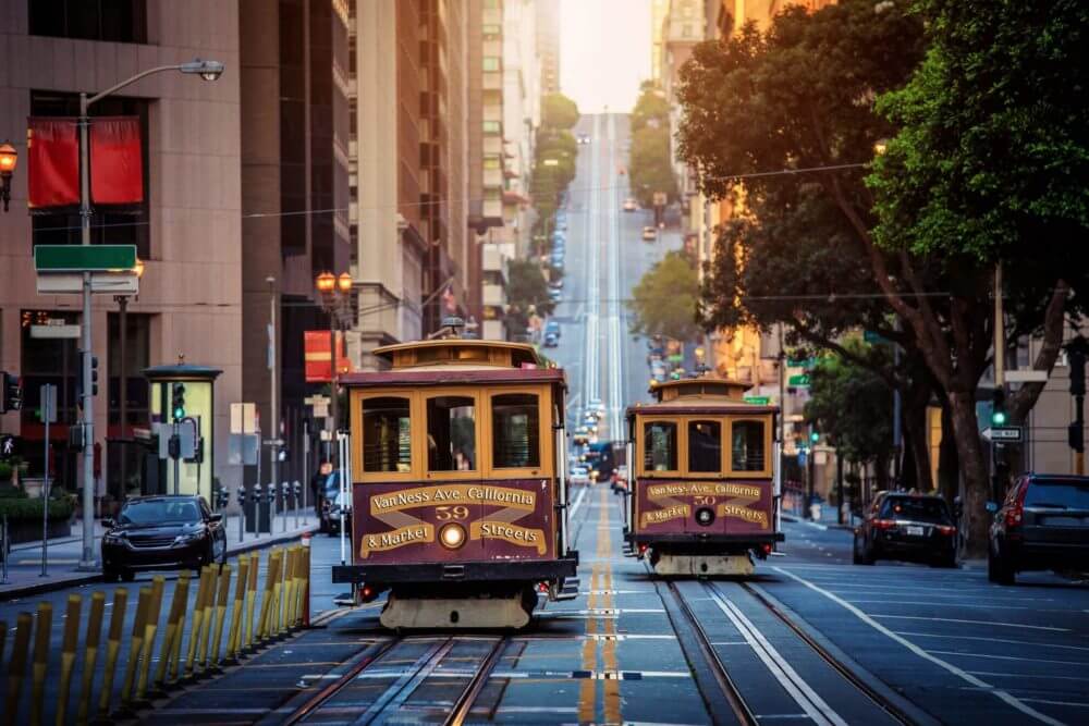 Two cable cars passing each other on the streets of SF