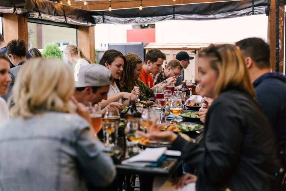 Group of happy friends having lunch in the restaurant