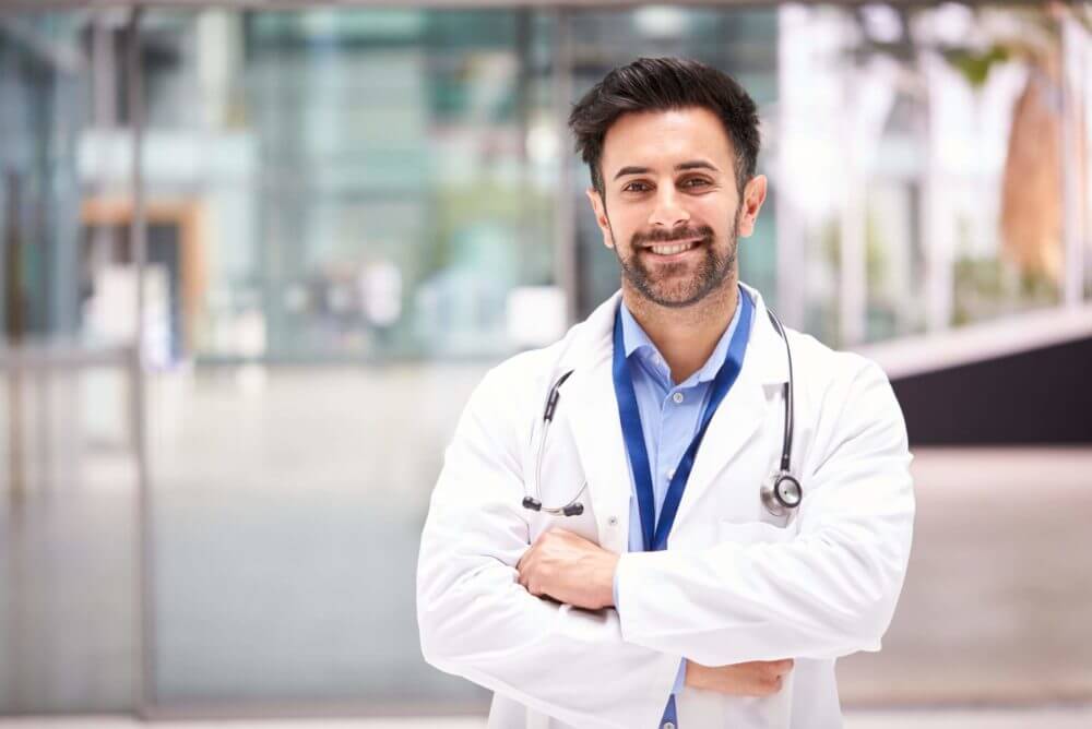 A doctor standing with crossed arms