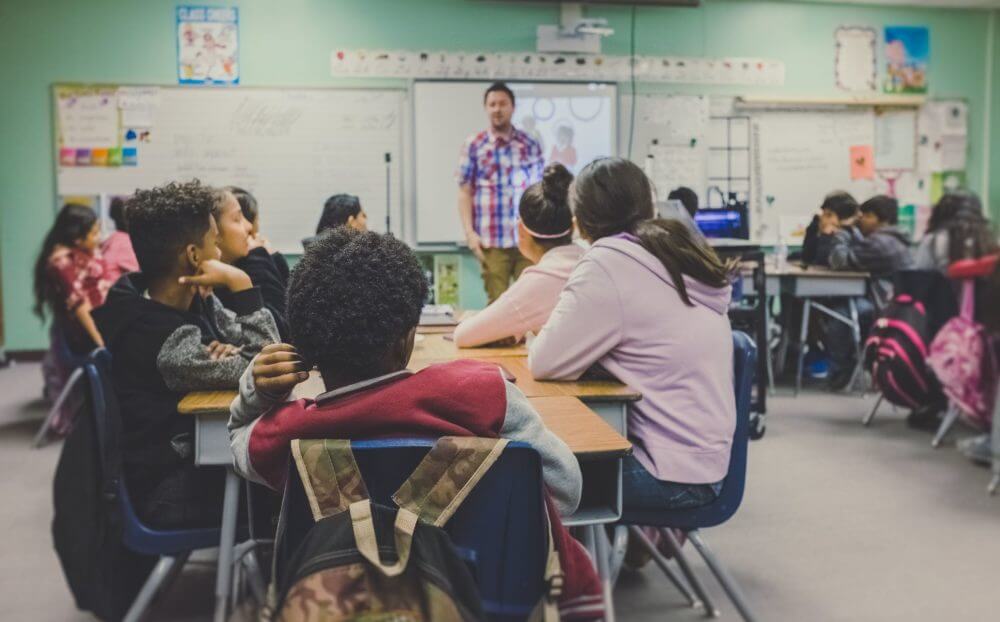 Kids sitting in class after long-distance moving 