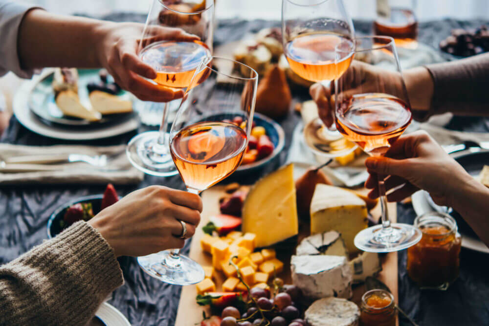 People clinking glasses with wine