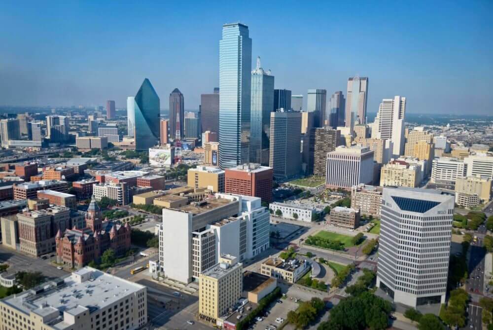 Bright daytime view of the Dallas skyline featuring modern city architecture.