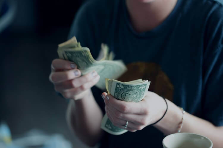 An unknown woman counting cash