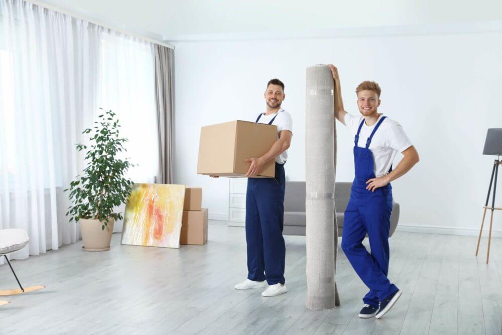 professional movers carrying boxes and carpet