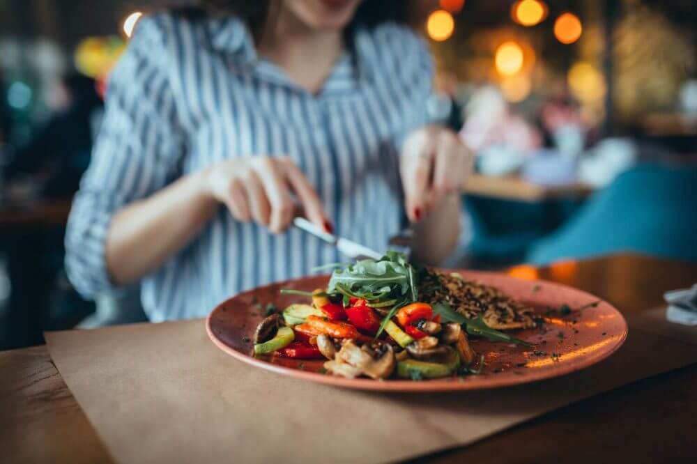 Young woman sitting in the restaurant and eating