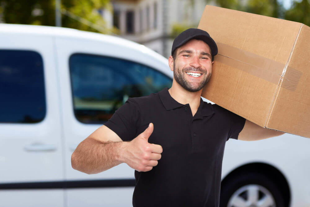 a mover holding a box on his shoulder 