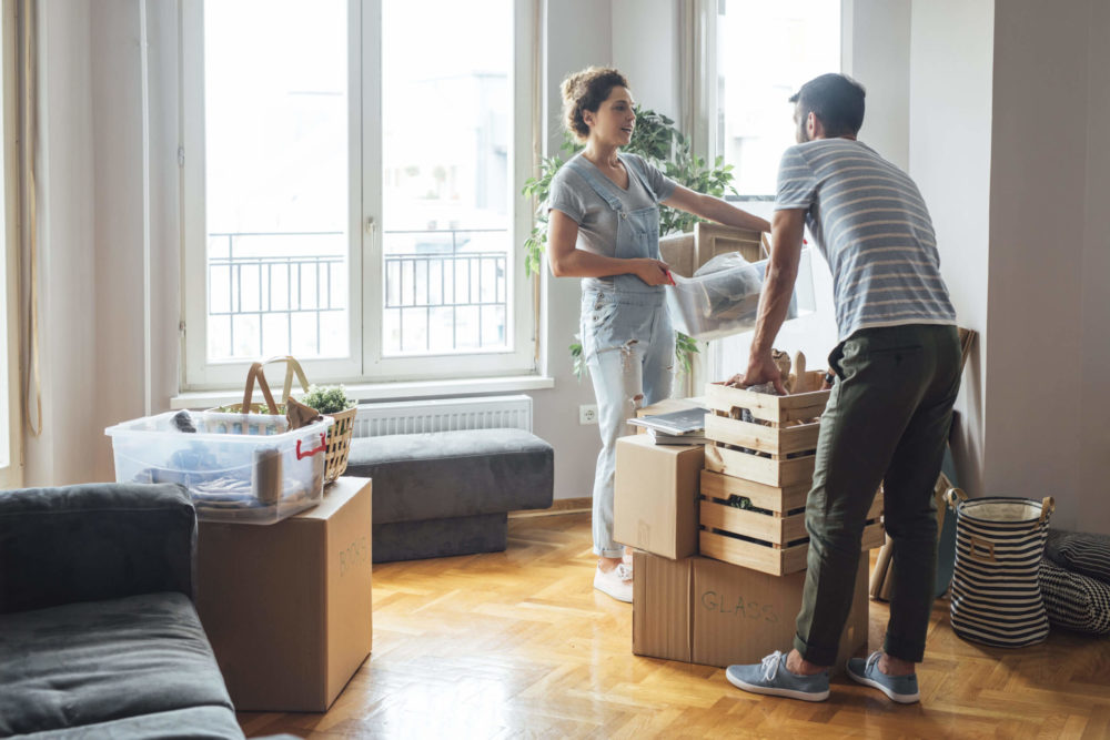 Man and woman, packing boxes and chatting, having fun