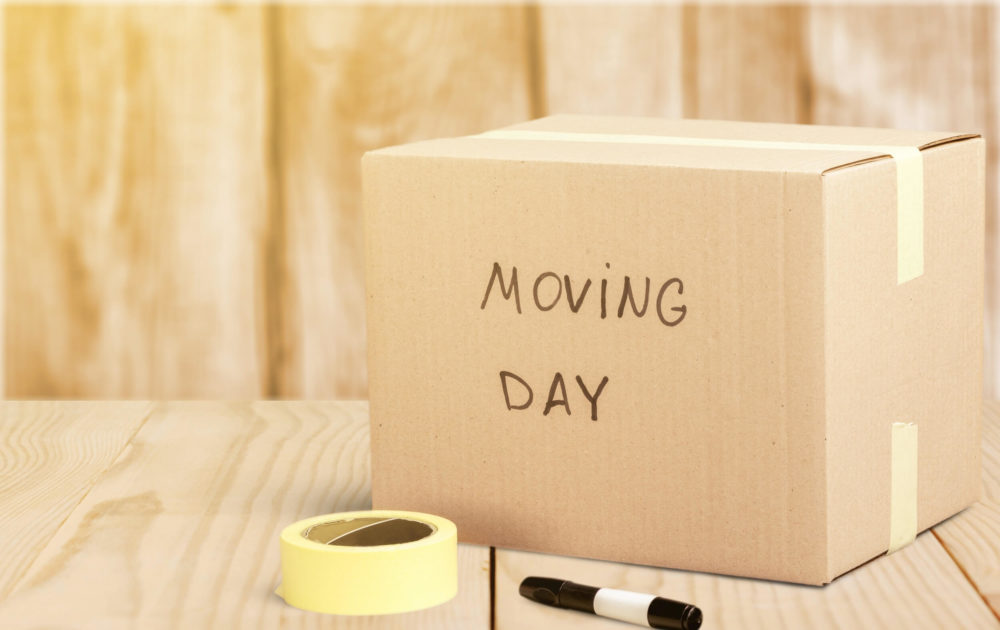 box with moving day written on it