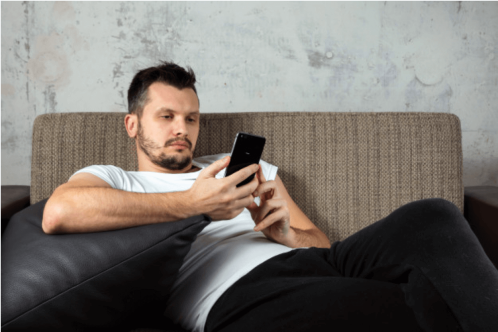 A young man watching at his phone 