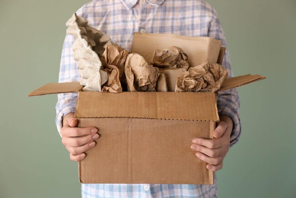 A man holding supplies getting ready for cross-country moving