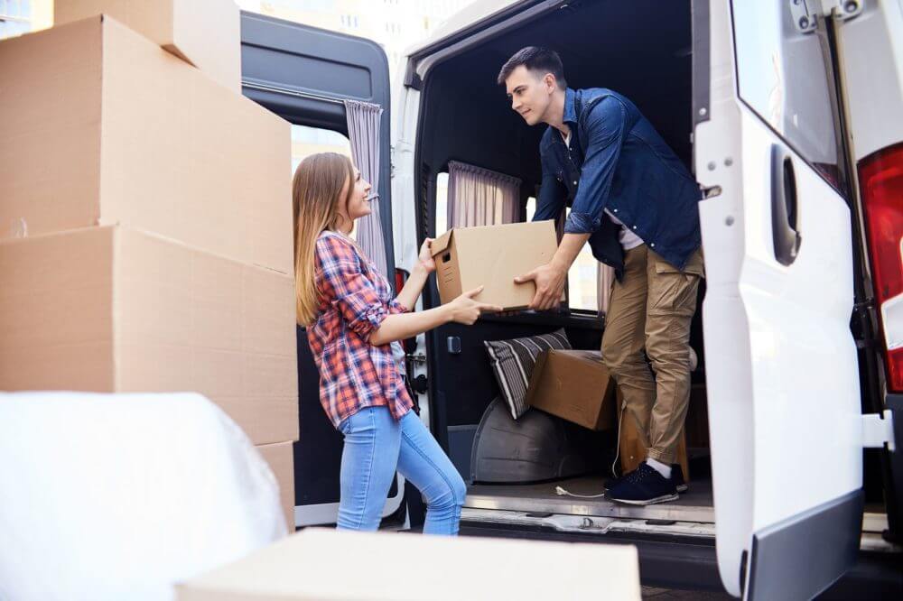 couple packing up a moving truck