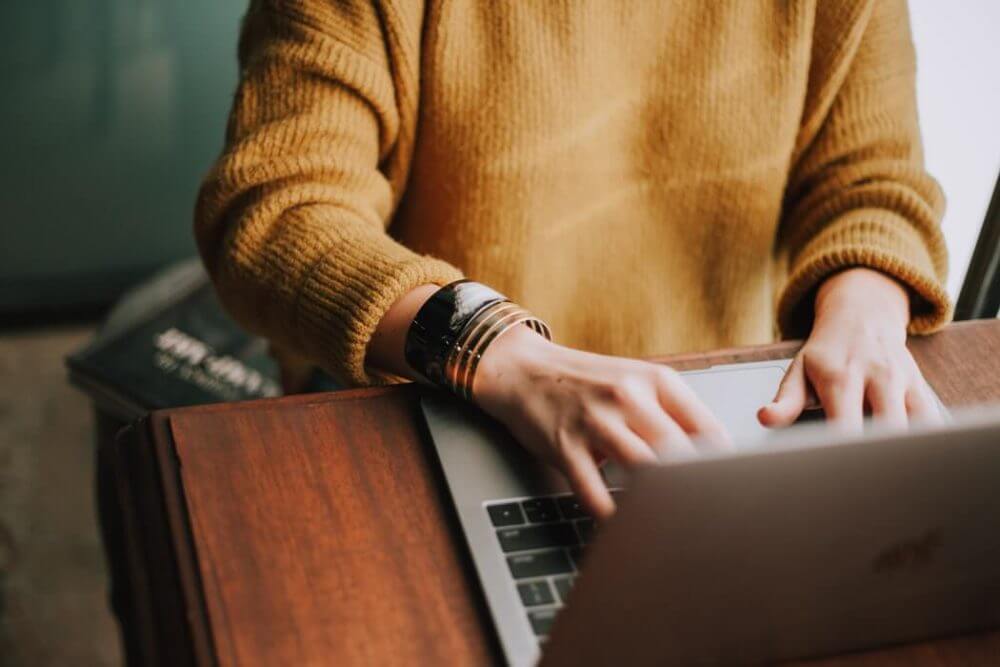 A person researching a long-distance moving company on a laptop