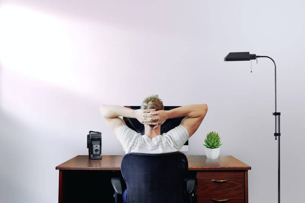 a person sitting and looking at the PC screen