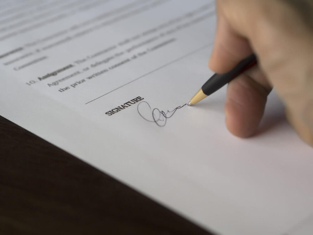 person signing up a document