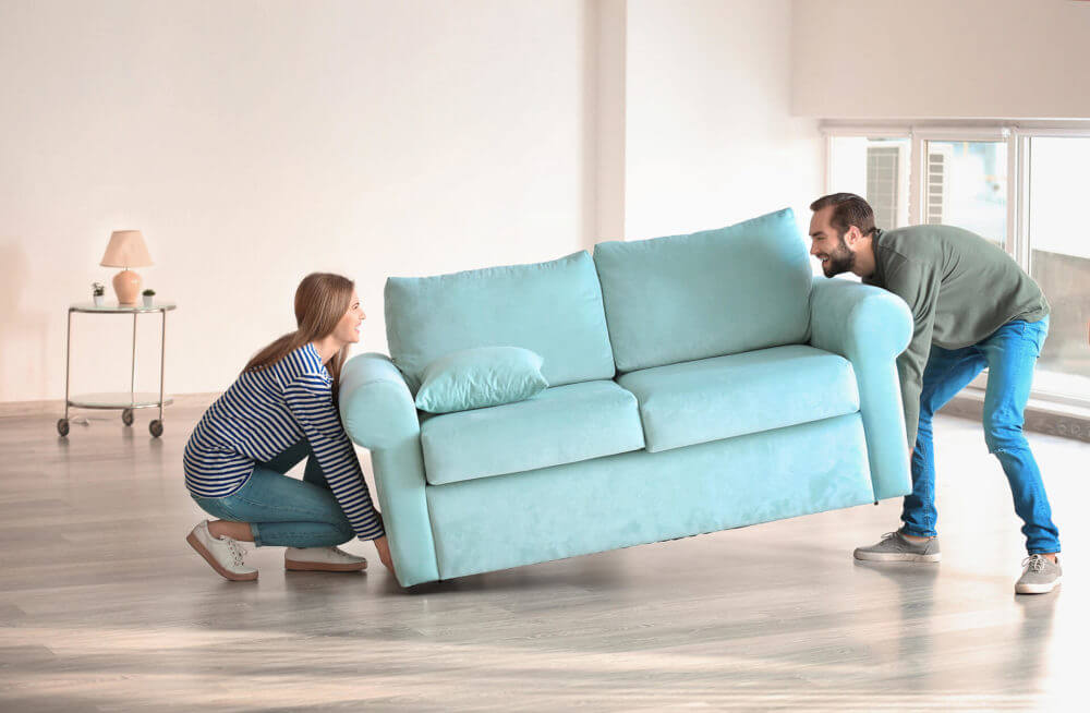 couple carrying a couch