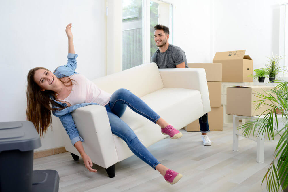 couple lifting a couch