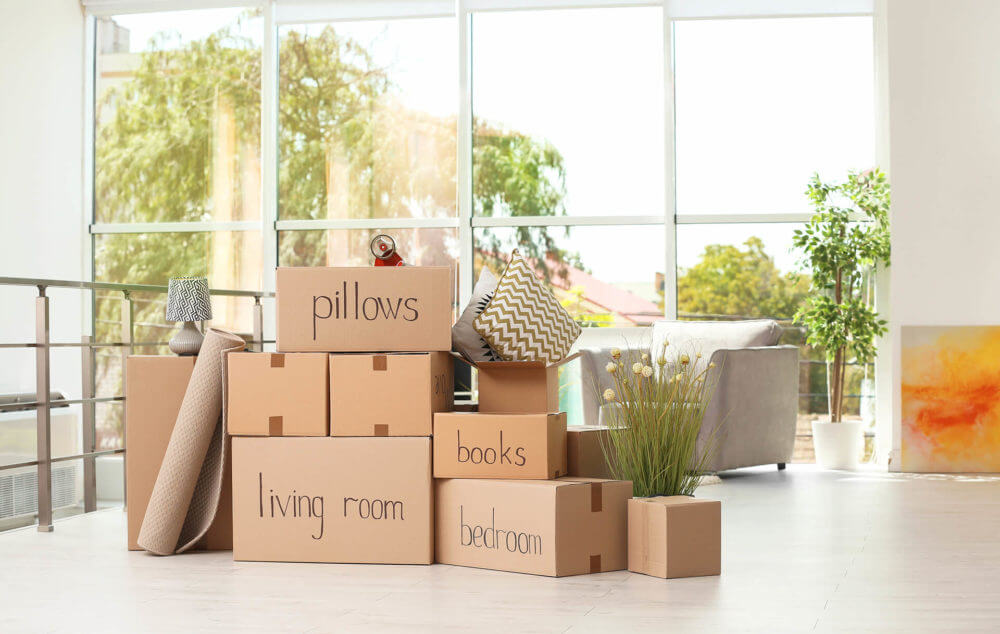 A pile of neatly stacked and labeled boxes ready for long-distance movers 