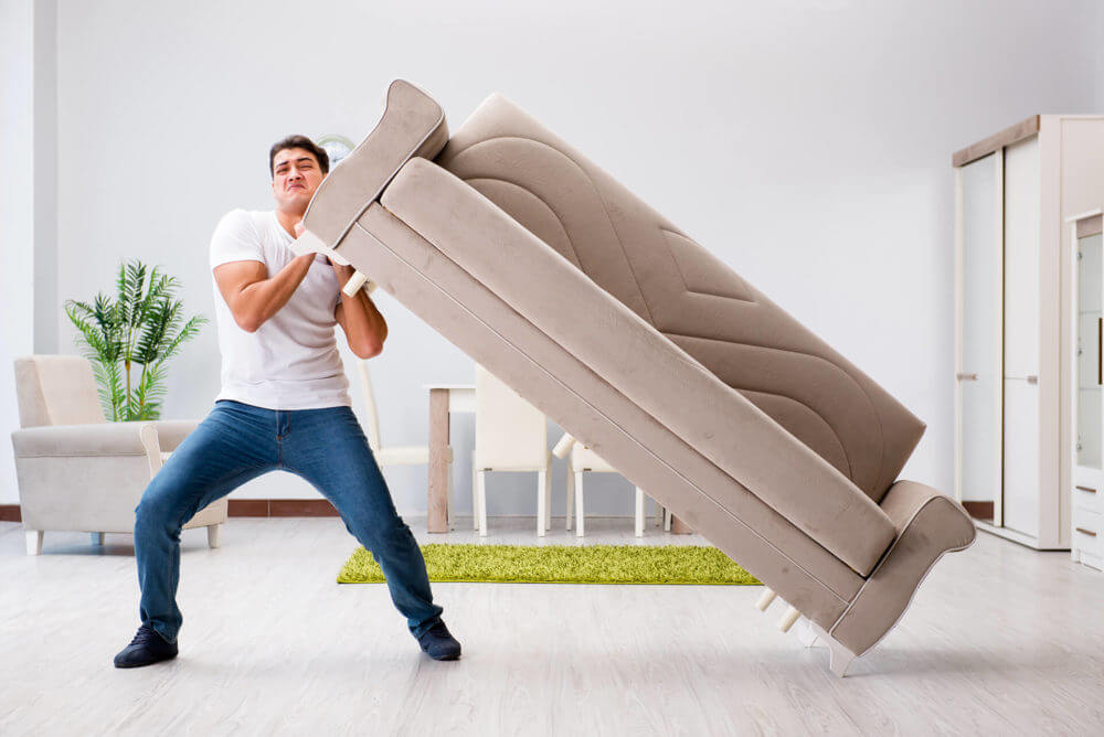 a white sofa covered with blankets