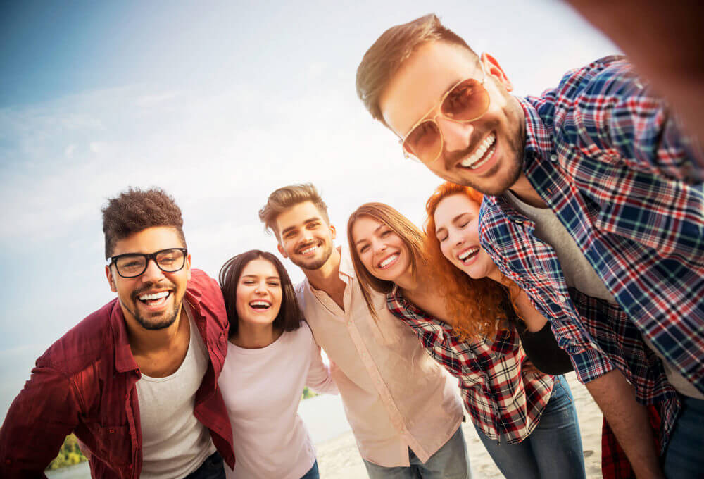 A group of people taking a selfie after hiring long-distance moving company 