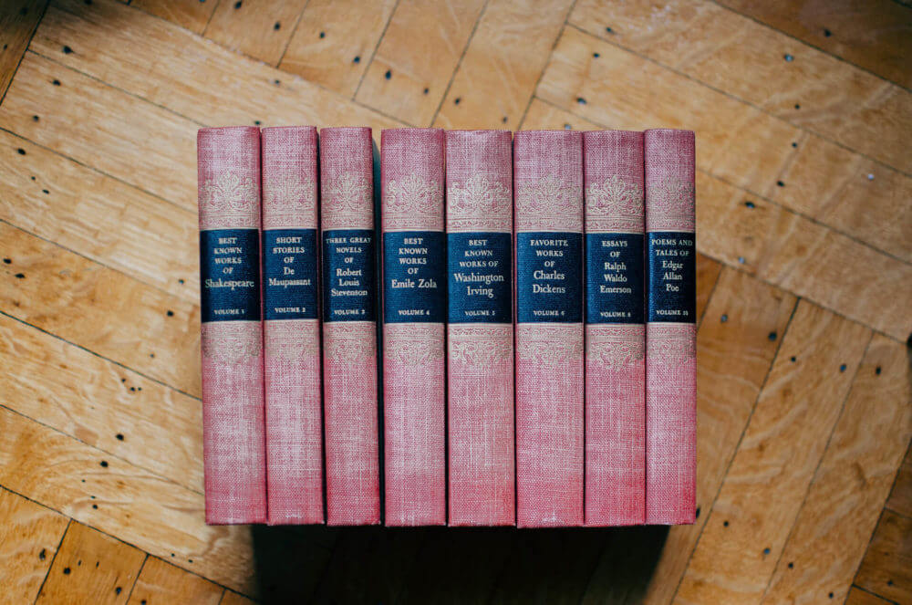 a collection of books on a wooden surface