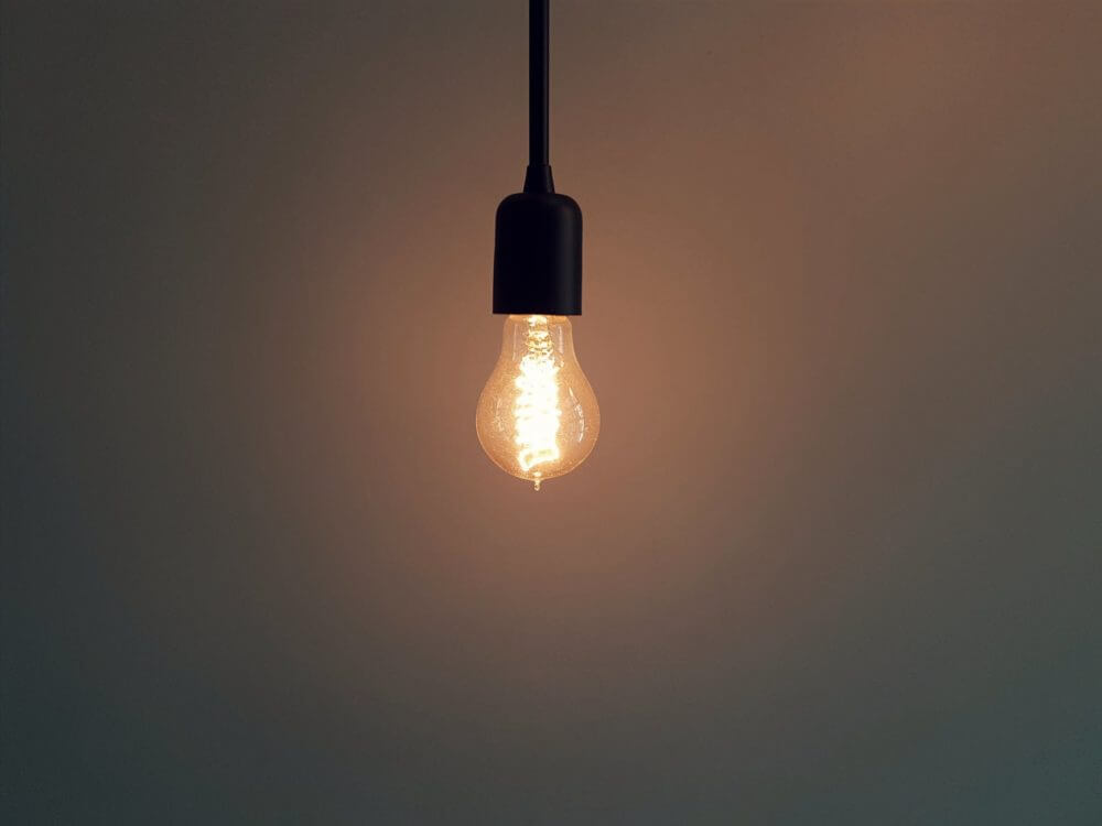 A single lit lightbulb hanging