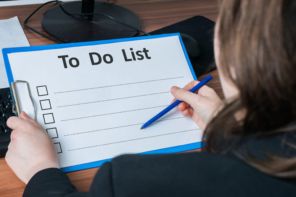 a woman filing a long-distance moving to-do list