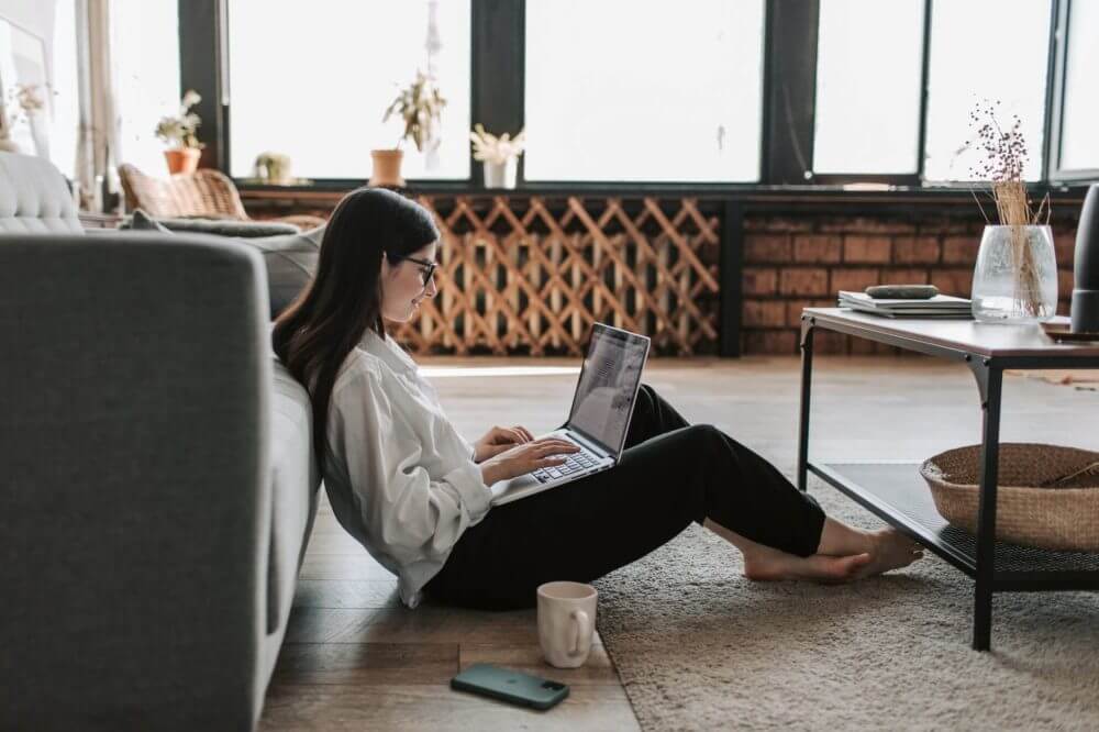 Woman sitting on the floor with a laptop