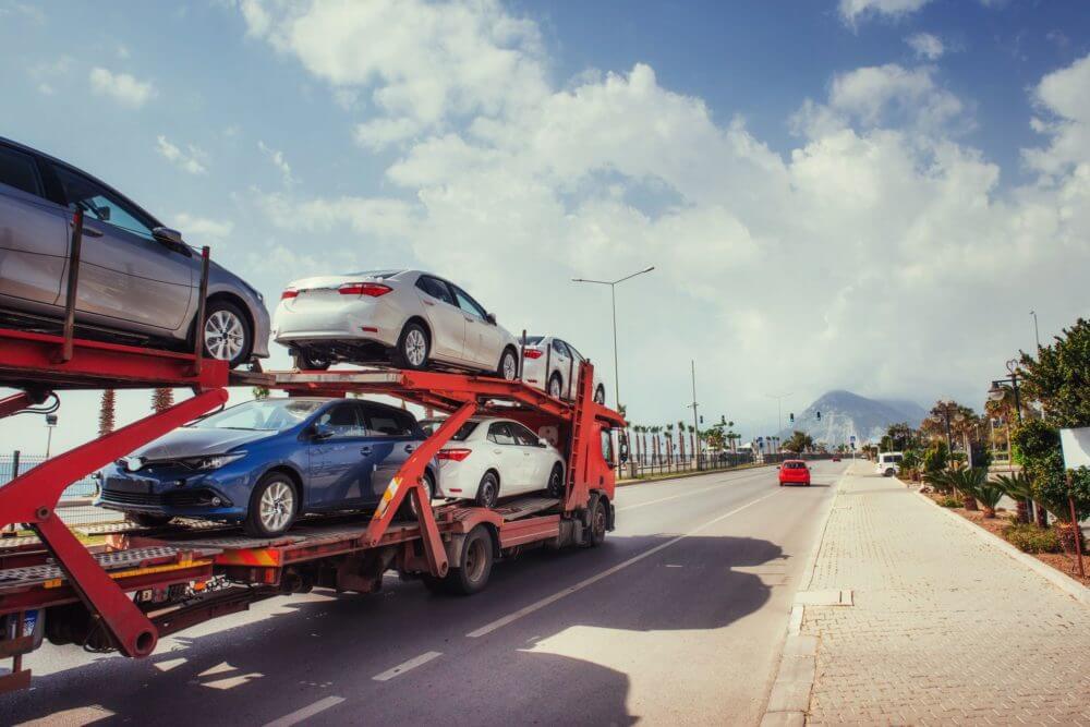 Auto transport company is transporting cars on an open trailer