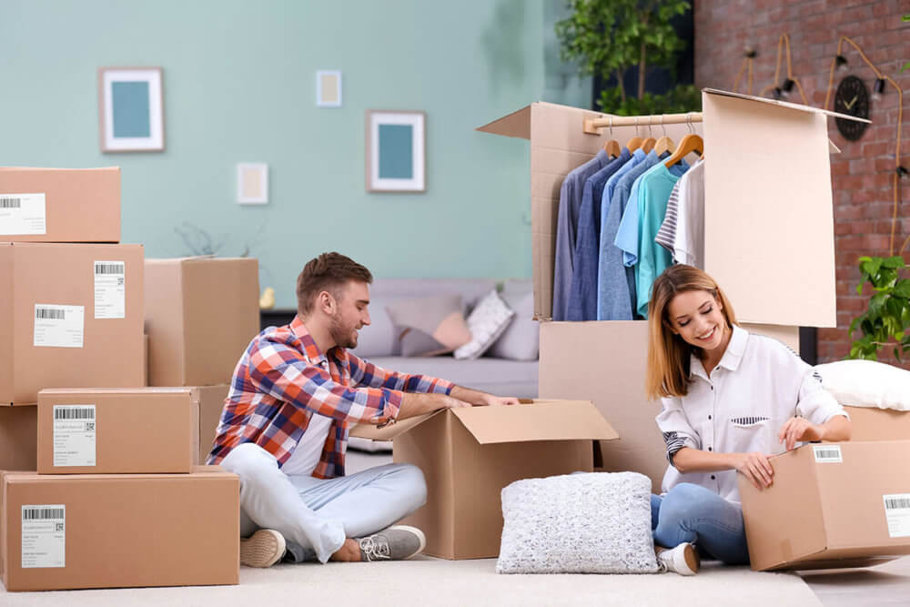 A couple boxing up their stuff for long-distance moving