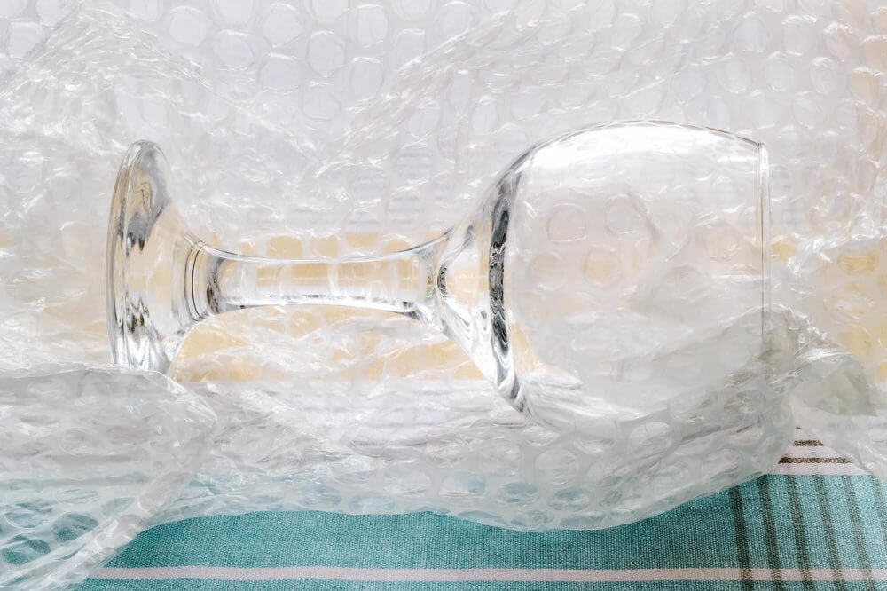 a wine glass laying in bubble wrap