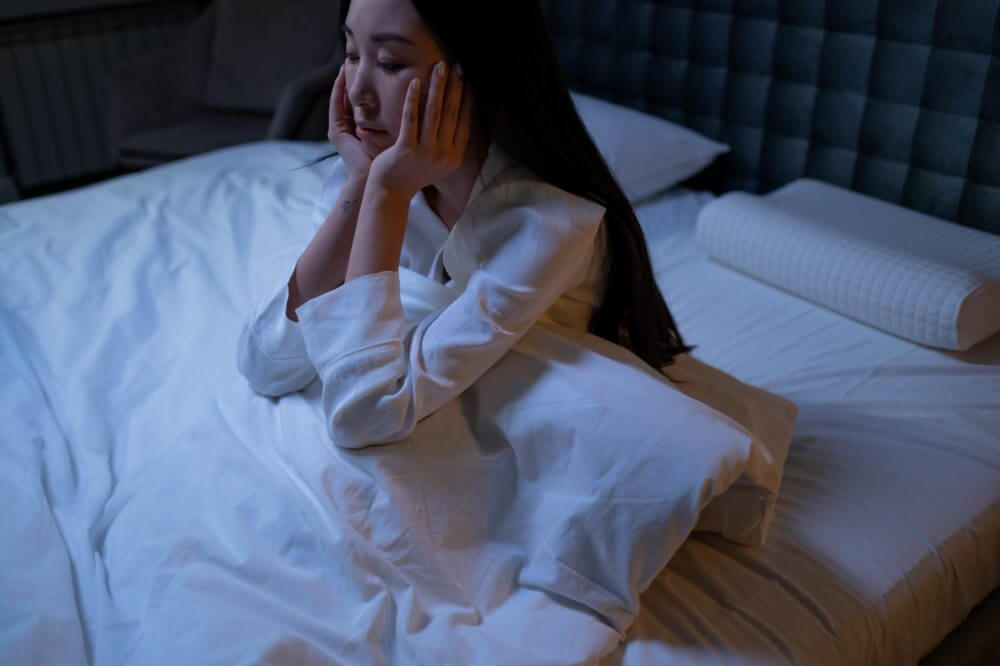 A woman coping with insomnia after long-distance moving