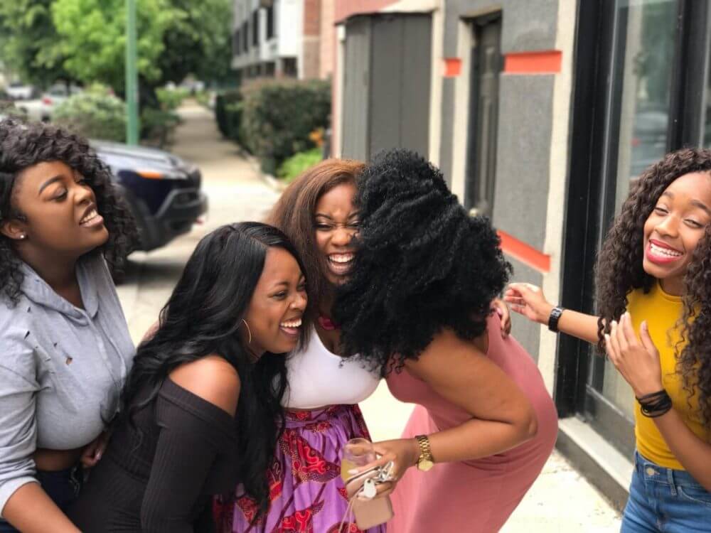 A woman laughing with her new friends after the cross-country moving