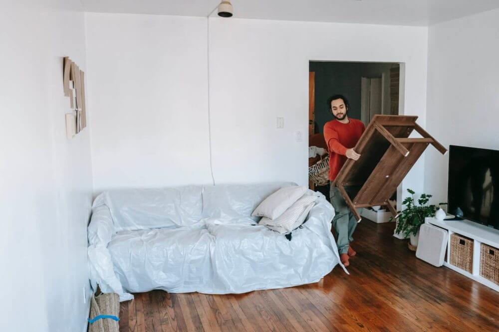 a man carrying a wooden table