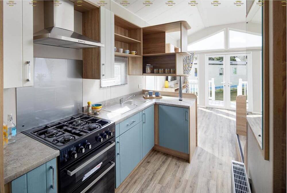 a pale blue kitchen with a gas stove